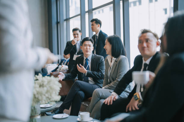 group of multiracial asian business participants casual chat after successful conference event - 会议 個照片及圖片檔